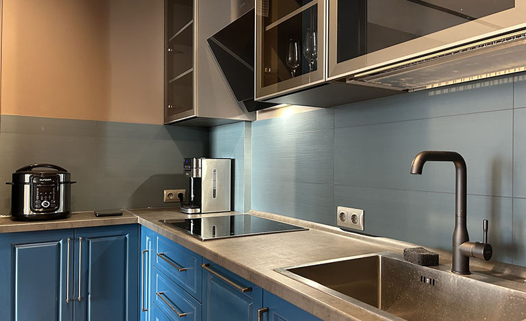 Синяя кухня со стеклянными шкафами