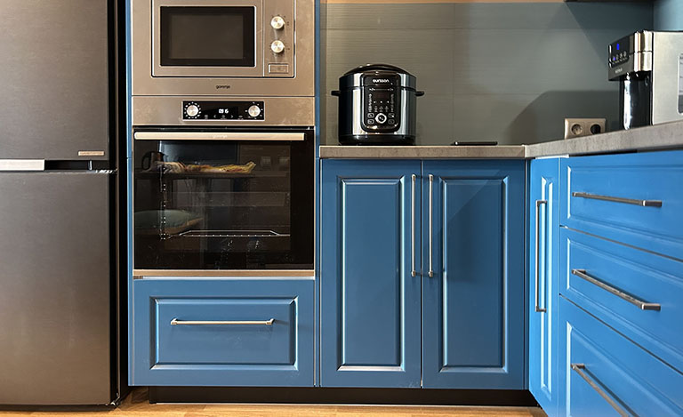 Синяя кухня со стеклянными шкафами